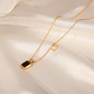 Gold plated titanium steel necklace with black rectangular pendant and small heart detail