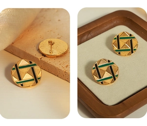Macro detail of gold-plated geometric stud earrings with green enamel and triangle motifs