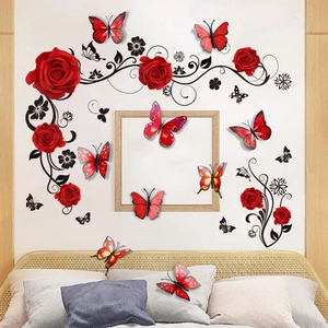 Detail of red rose wall decals with 3D butterflies and black vine accents on a bedroom wall