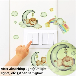 Luminous wall sticker showing cute animals and moon glowing in the dark around a switch