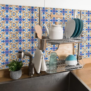 Blue and orange vintage Mediterranean floral tile stickers applied on a kitchen backsplash