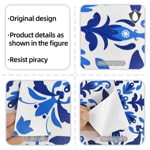 Detail of waterproof blue vintage floral tile sticker with textured PVC surface