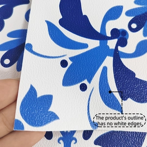 Macro view of blue floral tile sticker showing embossed texture and no white edge design