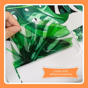 Detail showing the adhesive backing of tropical monstera leaf wall stickers