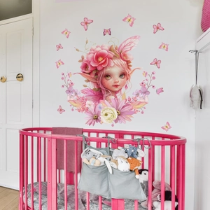 Whimsical fairy girl wall decal with pink flowers and butterflies in a cozy nursery