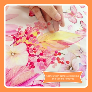 Detail showing self-adhesive removable pink flower and butterfly wall decal application