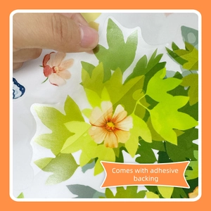 Macro detail of transparent PET wall sticker with orange flower and adhesive backing