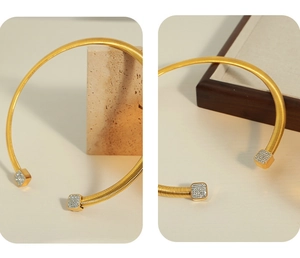 Detail of gold C-shape choker featuring flexible spring design and pavé square tips