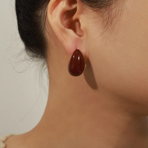 Minimalist dark brown water drop earrings in 18k gold plating shown on model
