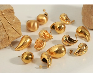 Macro shot of 18K gold plated teardrop earrings and necklace with zircon inlay