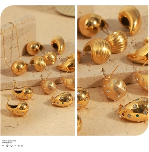 Macro view of chunky gold teardrop earrings with brushed finish and zircon details