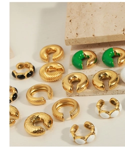 Detail of 18K gold plated hoop earrings with colorful enamel and textured finishes