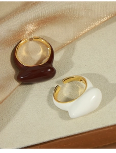 Detail of creative water drop open rings in brown and white with 18K gold plated finish