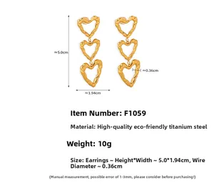 Detailed view of triple-heart gold titanium earrings with lava texture and dimensions