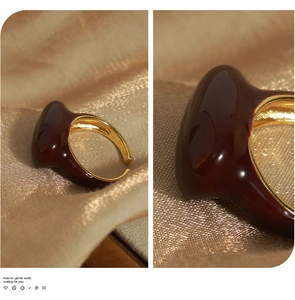 Detail of teardrop enamel ring with polished gold-plated adjustable open band