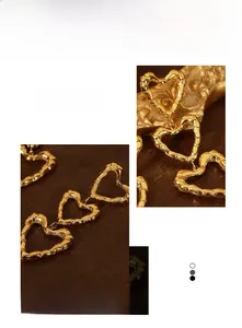 Detailed view of triple heart gold earrings featuring a textured bamboo pattern finish
