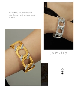 Detail of wide link bracelets with hammer texture and cubic zirconia in gold and silver