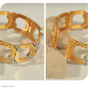 Detail of gold geometric chain bracelet featuring hammered metal and zircon inlays