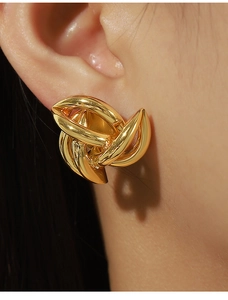 Close-up of elegant 18k gold plated twisted hoop earrings on a model's ear