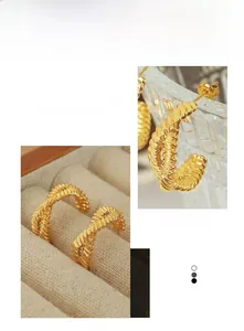 Detail of gold double-strand twisted hoop earrings with a vintage French luxury finish