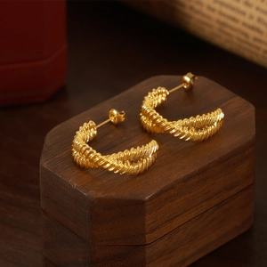 Elegant gold twisted rope C-shaped stud earrings in a vintage minimalist design