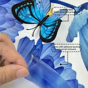 Detail of 3D blue butterfly wall sticker showing double-layer wings and adhesive backing
