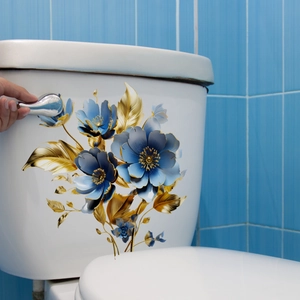 Blue and gold floral toilet lid decal with elegant leaves on a white ceramic tank