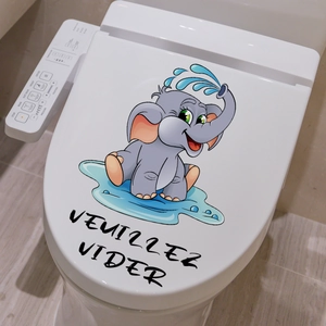 Detail of cute elephant bathroom sticker with French text on a white toilet seat lid