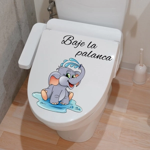Detail of cute elephant toilet sticker with Spanish 'Baje la palanca' reminder on white lid