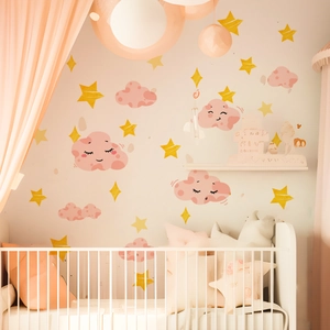 Detailed view of pink cartoon cloud and yellow star wall stickers in a cozy nursery room