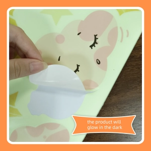 Detail showing self-adhesive backing and cartoon cloud glowing wall sticker peeling action
