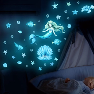 Glow in the dark ocean wall decals with mermaid, turtle, and stars in blue luminous light
