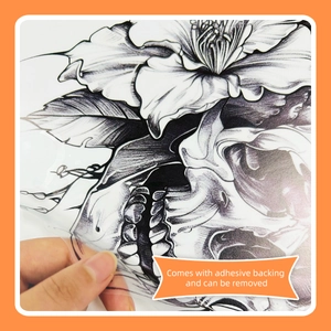 Close-up of black skull flower wall sticker with adhesive backing being peeled off