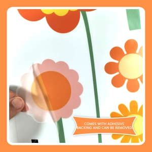 Detail showing self-adhesive colorful flower wall stickers being peeled for easy application