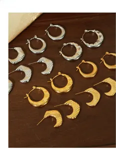 Detail of French vintage gold-plated horn-thread earrings and star-embossed hoops