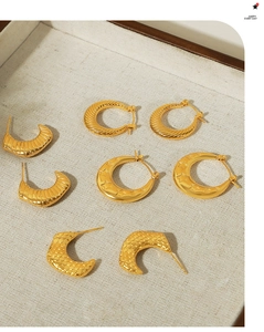 Detailed collection of gold plated hoop earrings with textured spiral and horn designs
