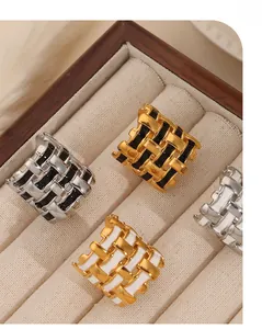 Detailed macro view of woven 18k gold plated titanium rings with colorful enamel drips