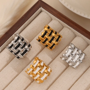 Retro braided metal rings set in 18k gold and silver with black and white enamel drip