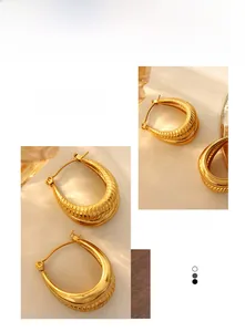 Detailed macro of 18k gold plated C-hoop earrings featuring smooth and twisted textures
