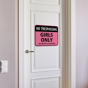 Pink and black Girls Only warning sign applied to a modern white bedroom door panel