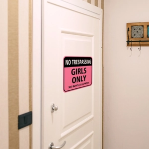 Pink and black Girls Only warning sign sticker on a white bedroom door for wall decor
