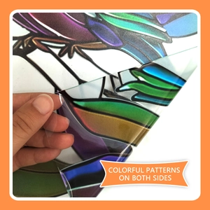 Close-up of double-sided colorful bird and leaf glass sticker with peel-off backing