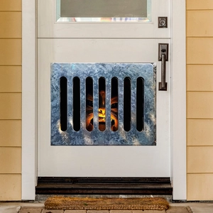 Close-up of a 3D monster wall sticker on a door with realistic rusty metal fence effect