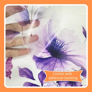 Detail of purple floral wall sticker showing the adhesive backing and PVC transparency