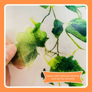 Detail showing transparent green leaf wall sticker with self-adhesive backing feature