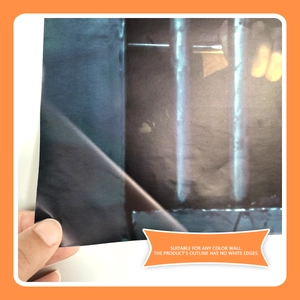 Detail showing transparent adhesive wall sticker being peeled to show no white border