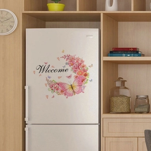 Close-up of pink floral wreath wall sticker with Welcome text on a white surface