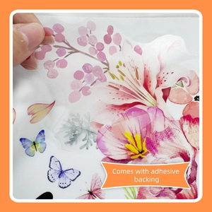 Close-up of watercolor floral wall sticker being peeled to show adhesive backing