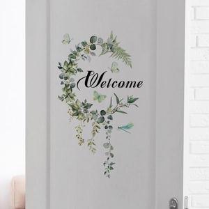 Detailed welcome door sticker with green eucalyptus wreath and blue butterflies on a white door