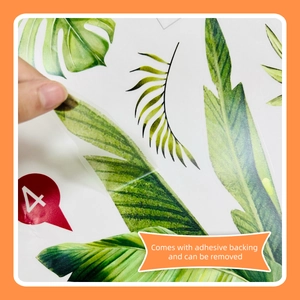 Close-up showing the self-adhesive backing of tropical green leaf wall stickers